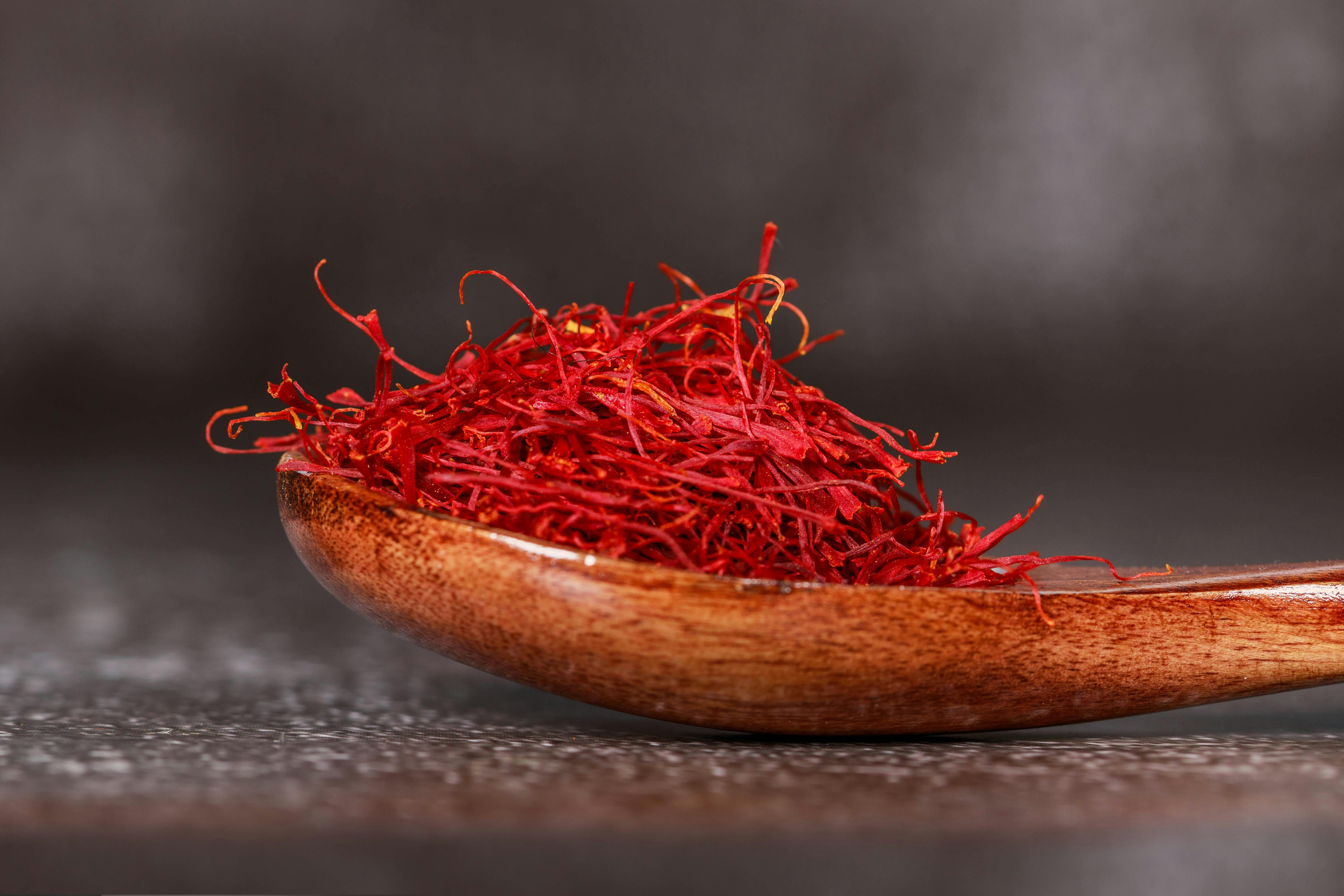 Premium saffron threads on a wooden spoon